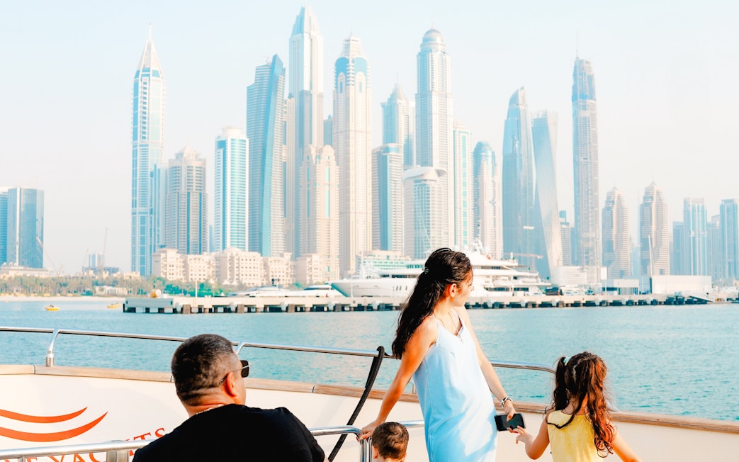 Luxury yacht tour with Dubai Marina skyline in the background.