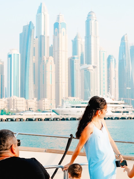 Luxury yacht tour with Dubai Marina skyline in the background.