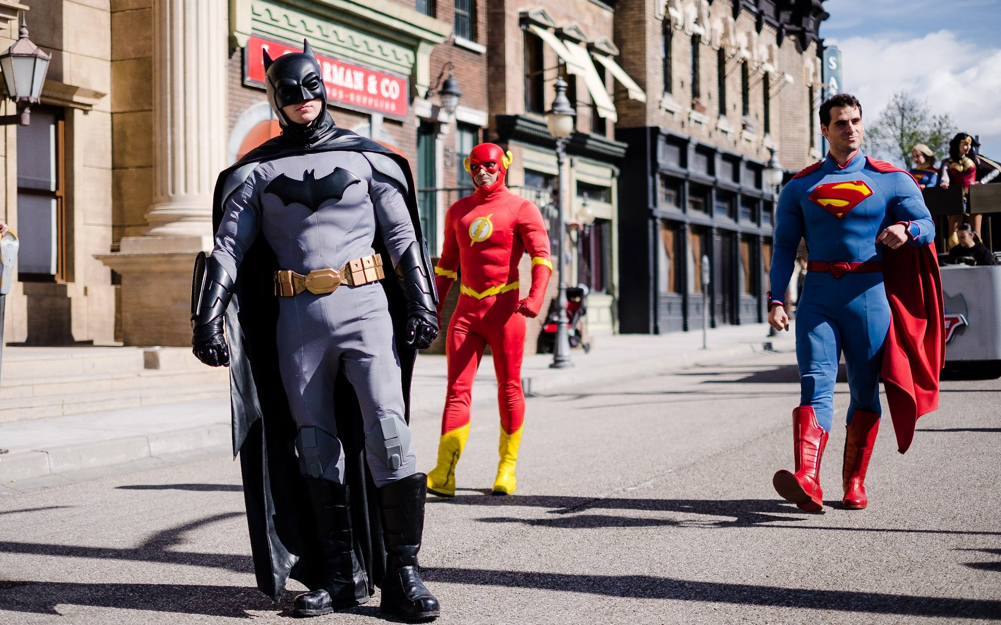 Batman, The Flash, and Superman walking in DC Super Heroes World at Parque Warner Madrid.