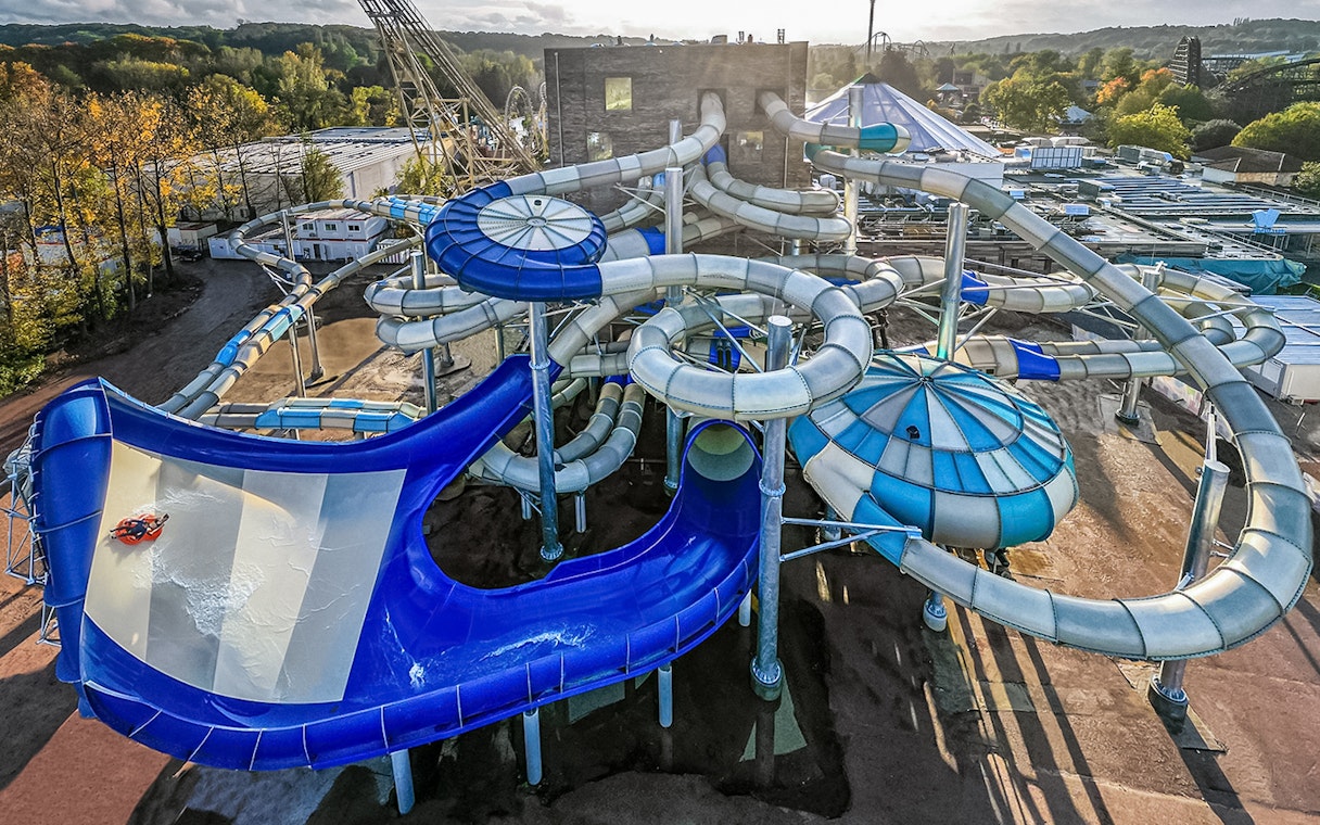 Tourists enjoying water slides at Aqualibi park.