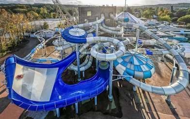 Tourists enjoying water slides at Aqualibi park.