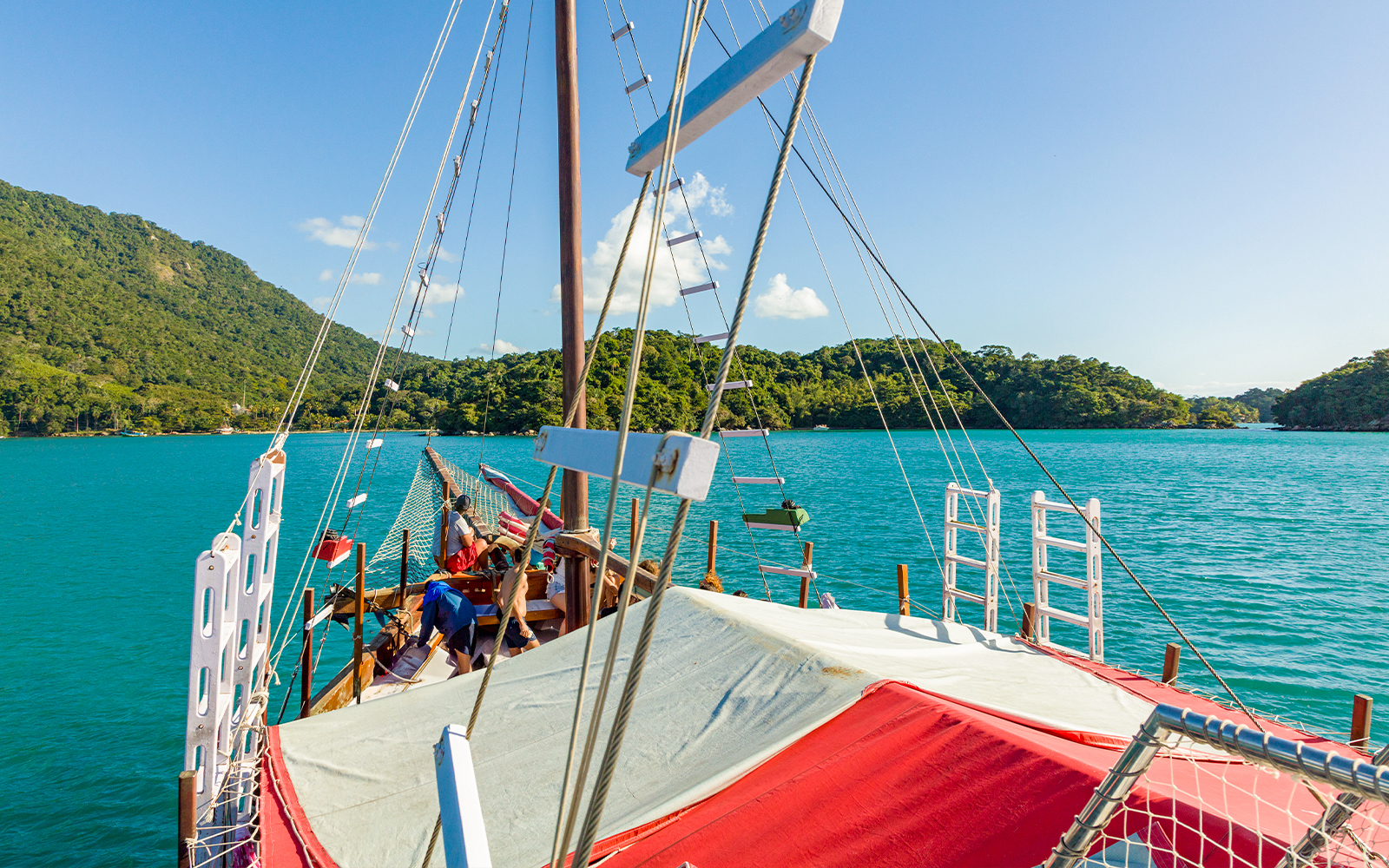 Tourist catamaran sailing near tropical Cataquases Islands, Ilha Grande.