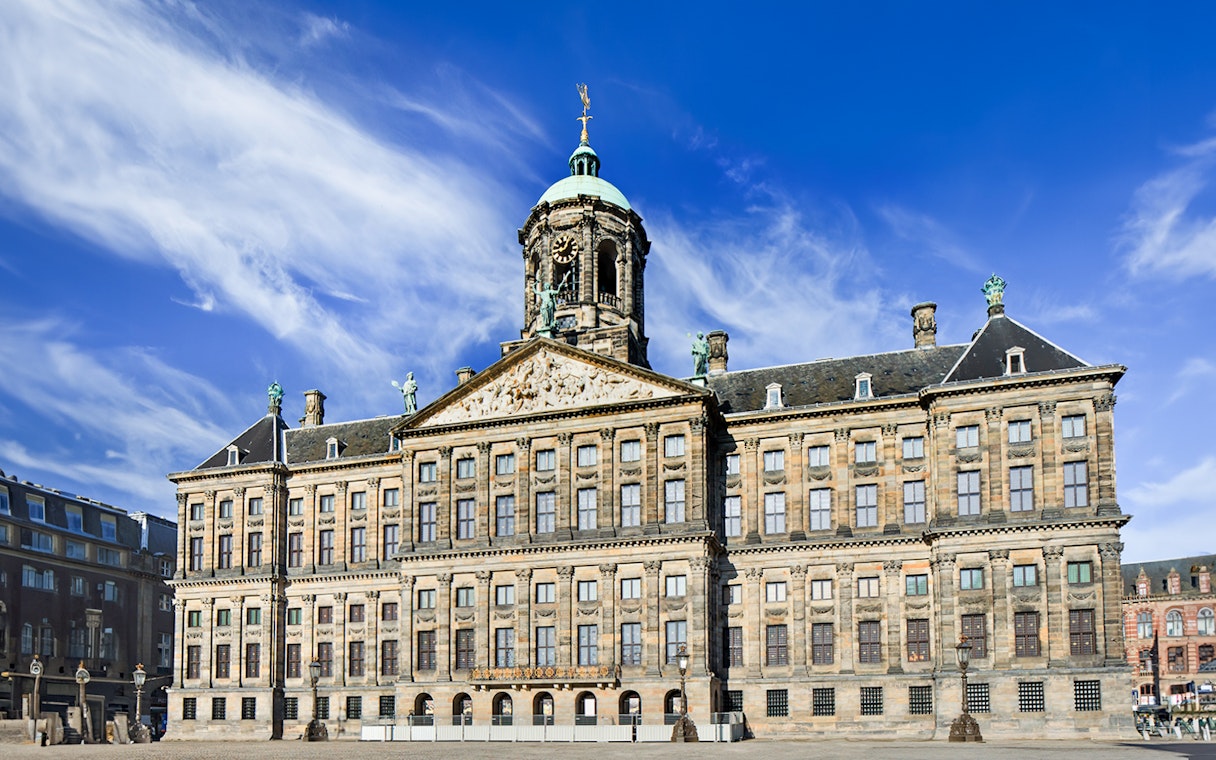 Royal Palace on Dam Square, Amsterdam, with clear blue sky.