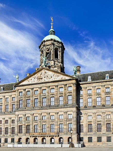 Royal Palace on Dam Square, Amsterdam, with clear blue sky.