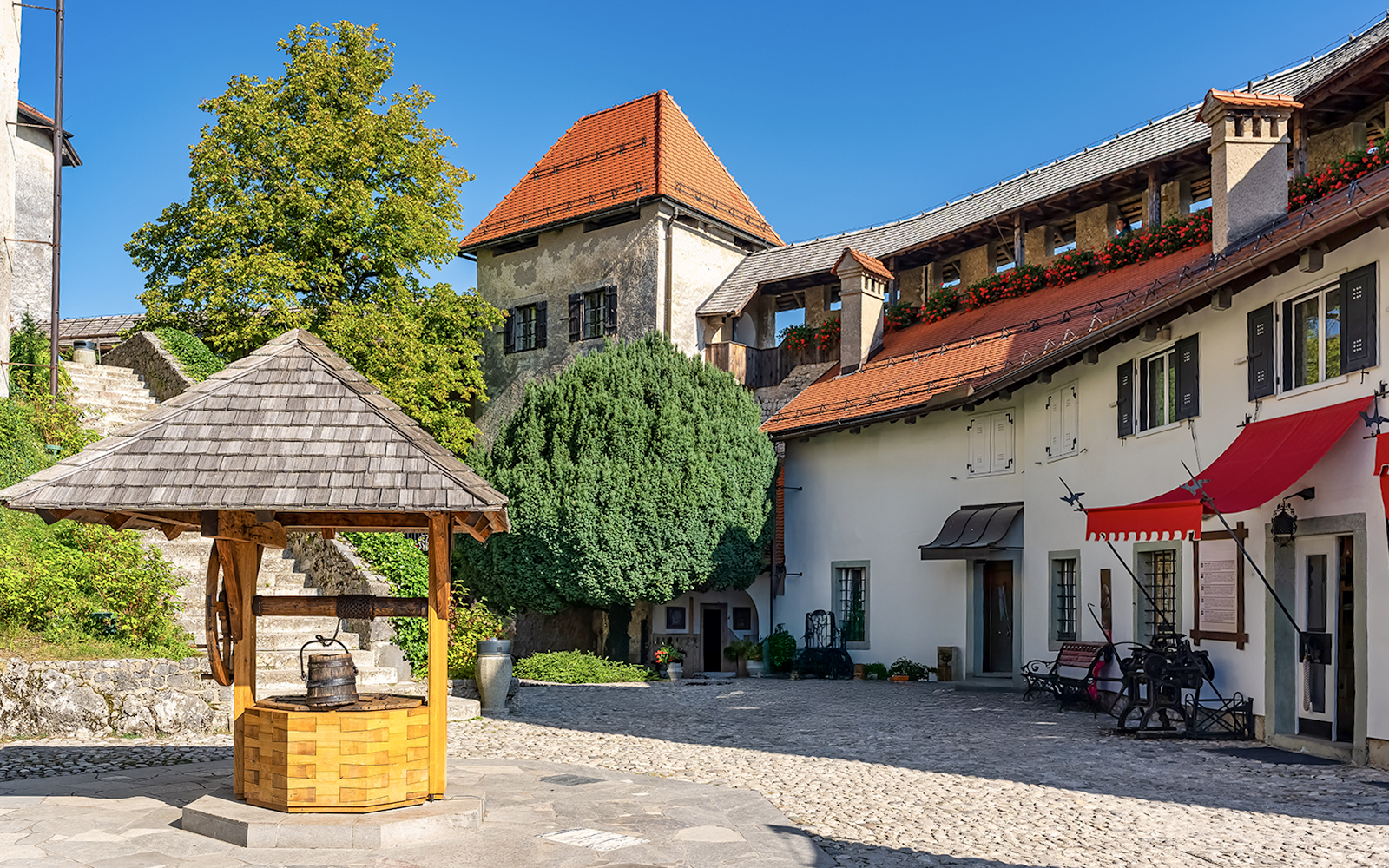 Lake Bled castle courtyard with well and historic buildings, Slovenia.