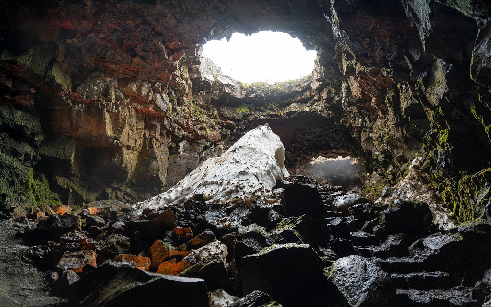 Raufarhólshellir Lava Cave interior with rock formations and natural light, Iceland.