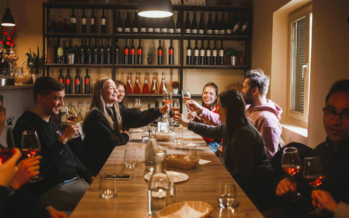 Group enjoying wine tasting at a table in Zadar during Krka National Park tour.