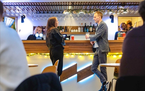 Guests enjoying drinks at the bar on a dinner cruise from Stavanger.
