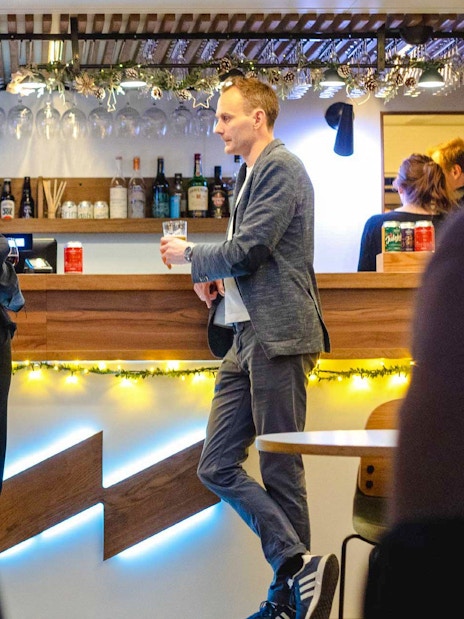 Guests enjoying drinks at the bar on a dinner cruise from Stavanger.