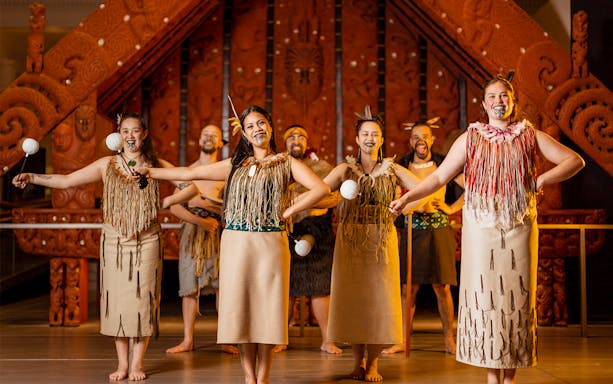 Maori performers in traditional attire at Auckland Museum.