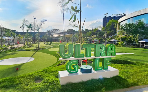 UltraGolf course with lush greenery and modern facilities under a clear sky.