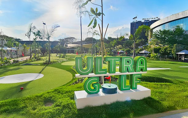 UltraGolf course with lush greenery and modern facilities under a clear sky.