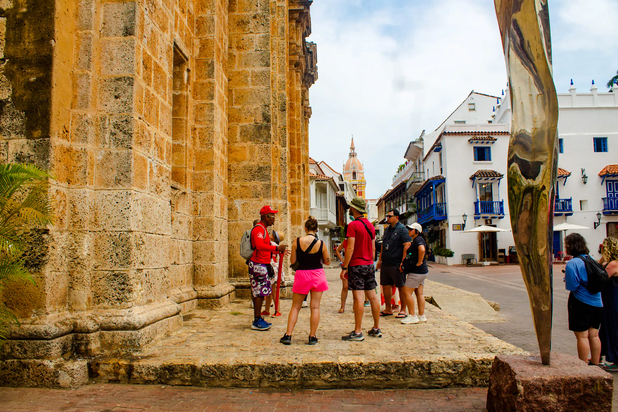 Tour group exploring Cartagena's Walled Old City with historic architecture in the background.