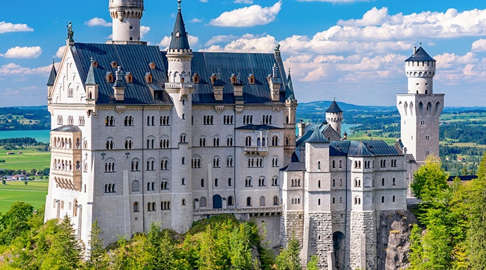 Neuschwanstein Castle in Bavaria, Germany, surrounded by lush green forest.