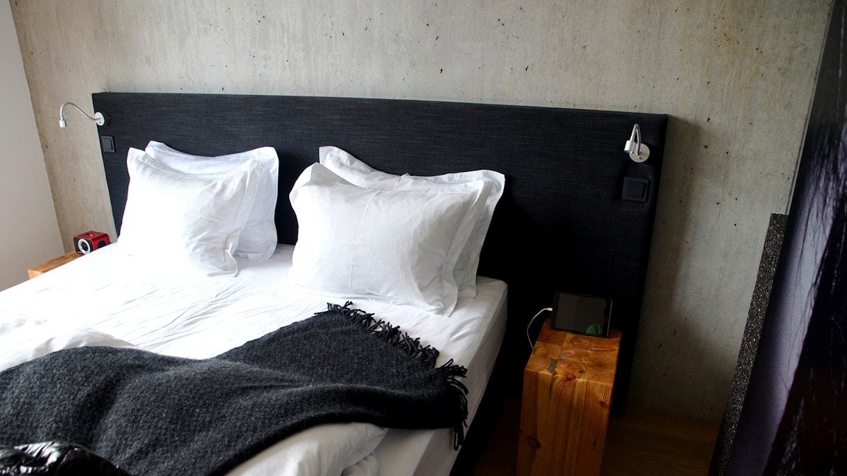 Vök Baths geothermal pools with steam rising, surrounded by Icelandic nature.