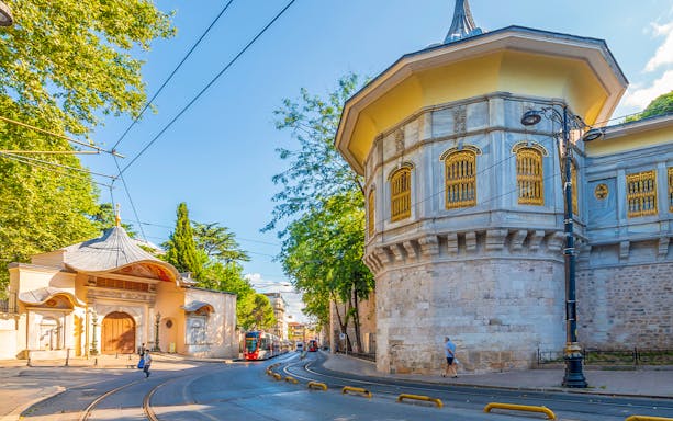 Tram passing by historic architecture in Istanbul near shuttle bus transfer route.
