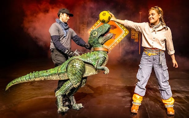 Dinosaur puppet performance at Dinosaur World Live, West End stage.