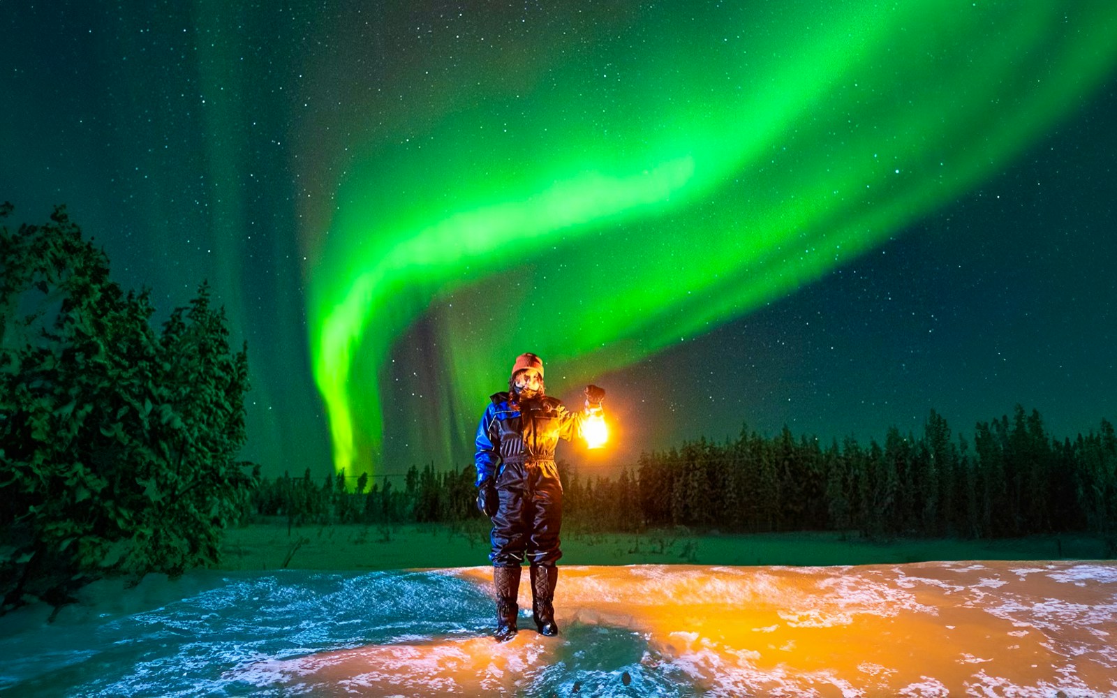 Guest photographing Northern Lights on Aurora expedition in Rovaniemi, Finland.