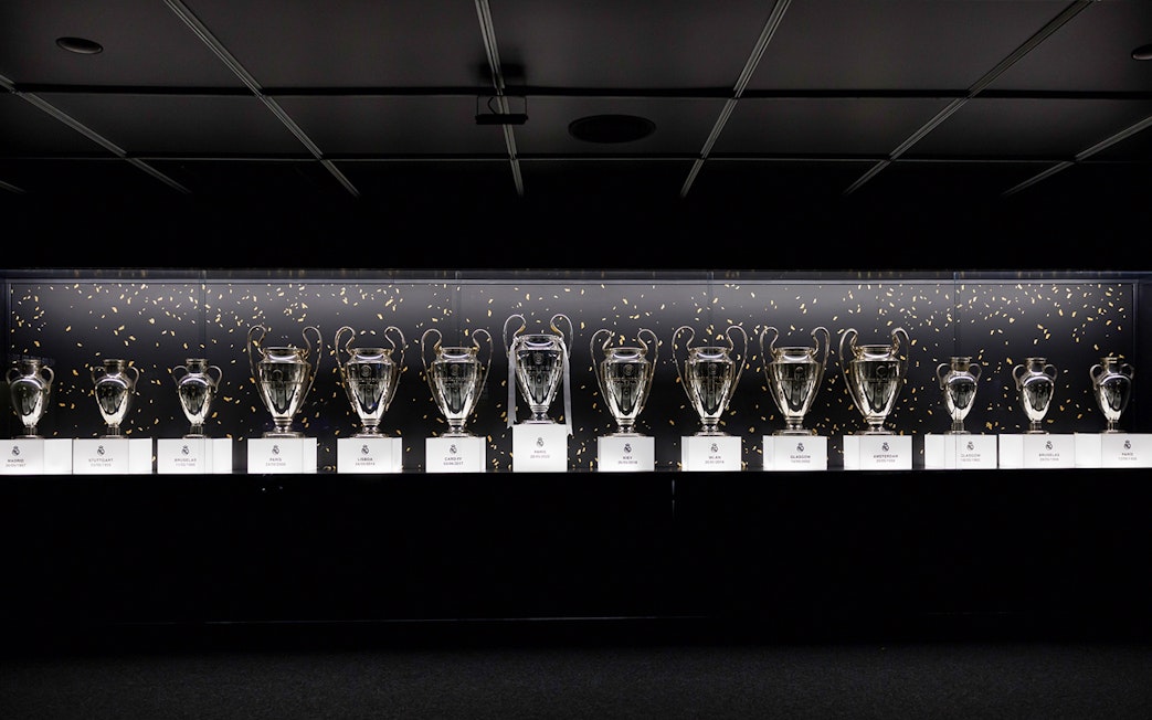 Trophies displayed in a row at Santiago Bernabéu Stadium.