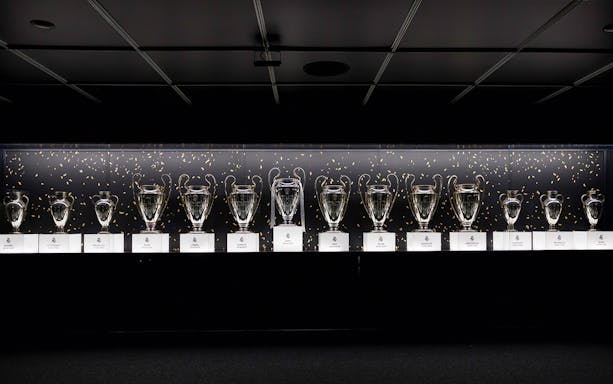 Trophies displayed in a row at Santiago Bernabéu Stadium.