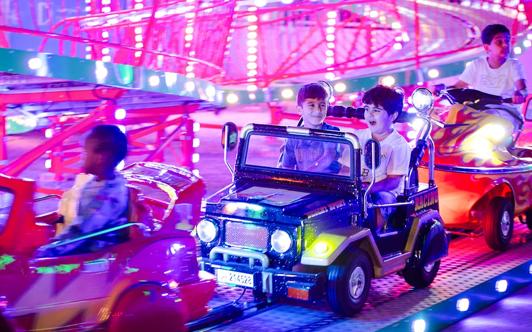 Children enjoying a colorful ride at Lusail Winter Wonderland.