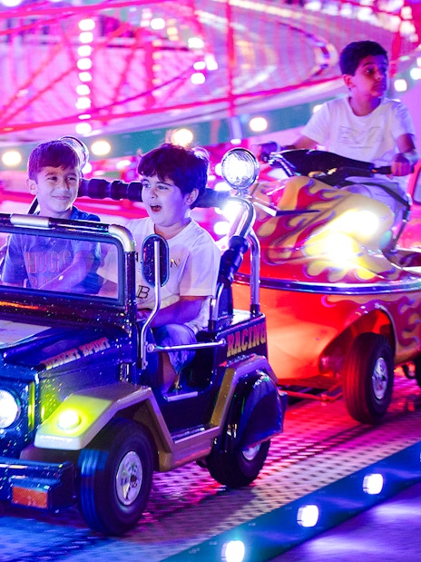 Children enjoying a colorful ride at Lusail Winter Wonderland.