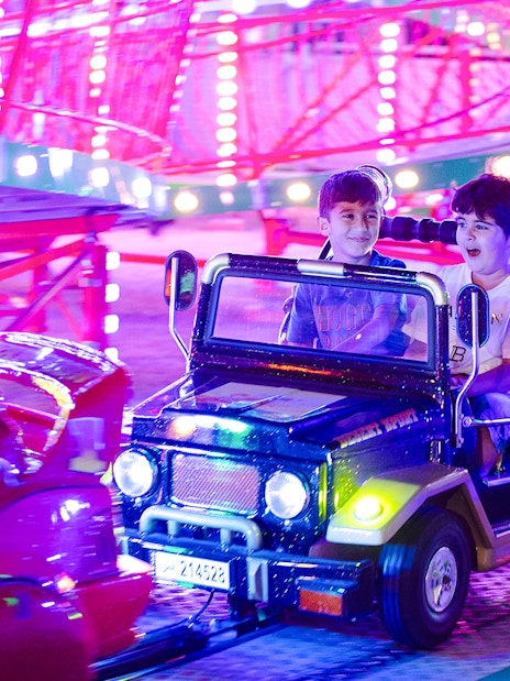 Children enjoying a colorful ride at Lusail Winter Wonderland.