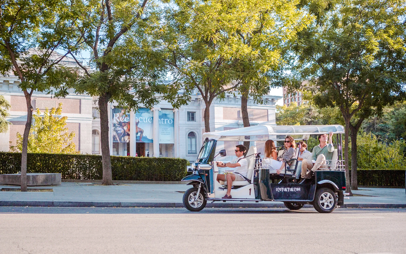 Electric tuk-tuk tour in Madrid passing the Prado Museum.