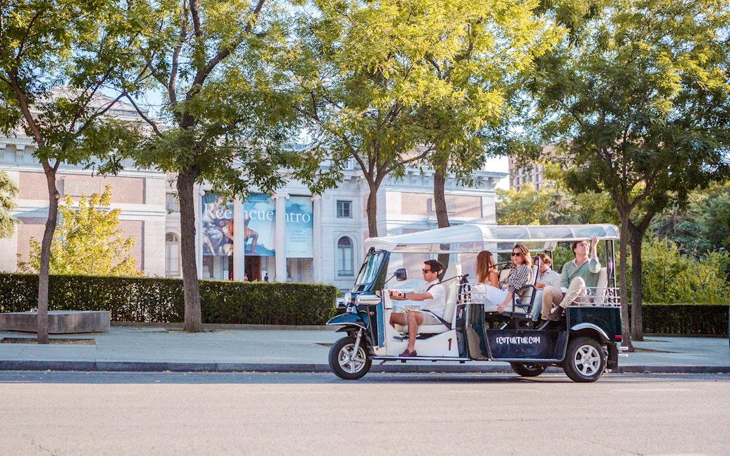 Electric tuk-tuk tour in Madrid passing the Prado Museum.