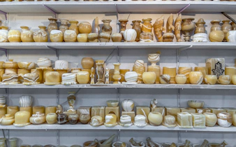 Onyx vases and candlesticks displayed on shelves in a Hurghada souvenir shop.