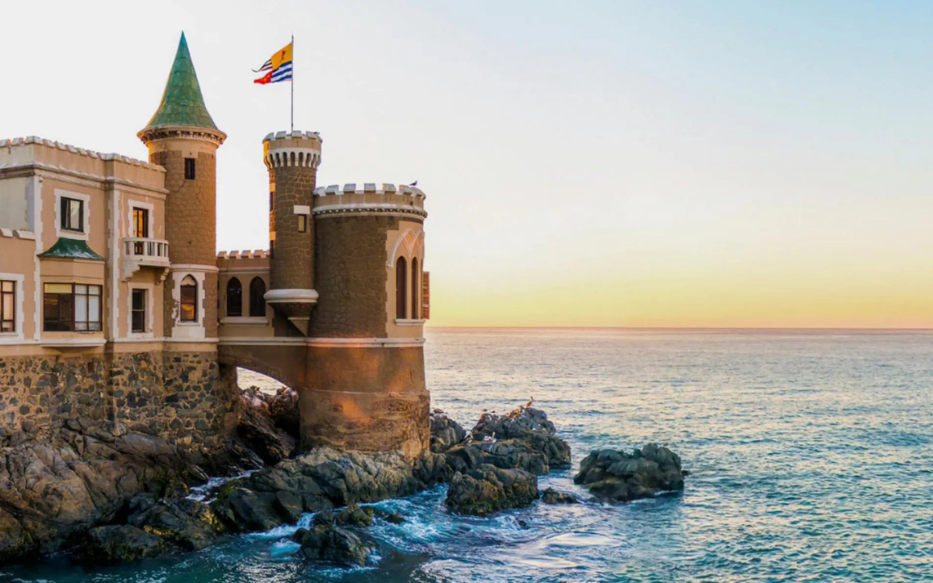 Wulff Castle on rocky shore at sunset in Viña del Mar, Chile.