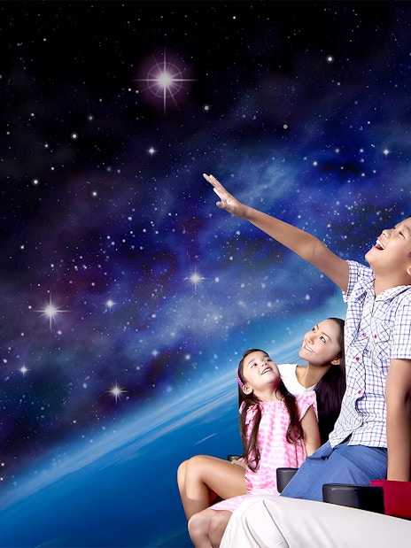 Visitors watching a space show at the Omni Theatre, Singapore.