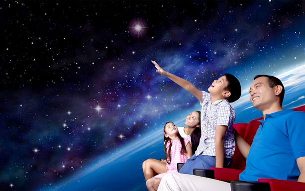 Visitors watching a space show at the Omni Theatre, Singapore.