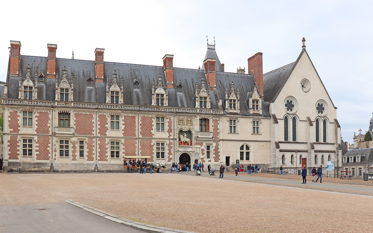 Blois Castle courtyard with visitors exploring the historic architecture.
