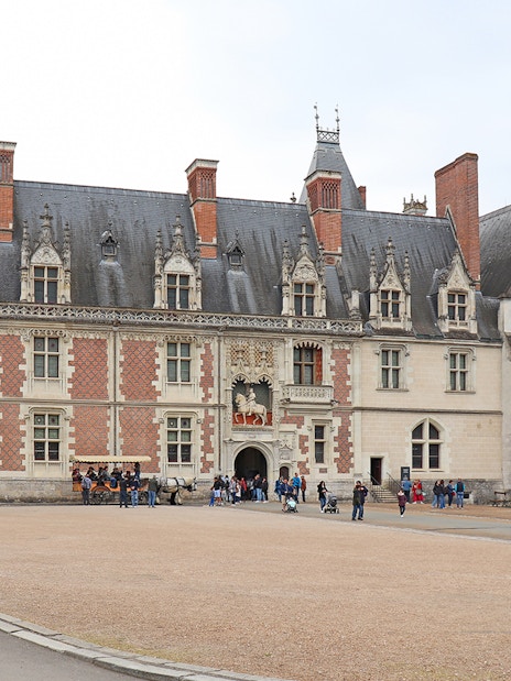 Blois Castle courtyard with visitors exploring the historic architecture.