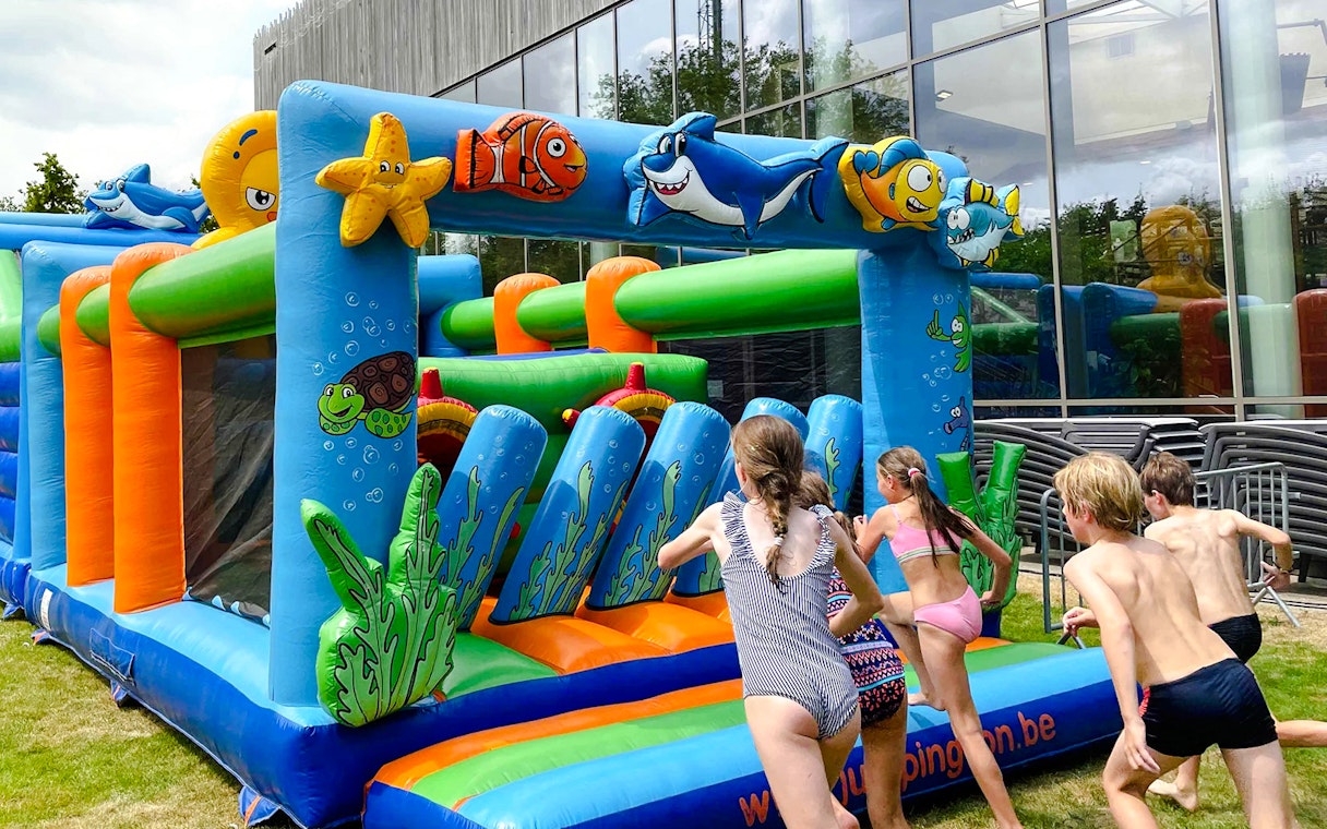 Children playing on an inflatable obstacle course at Bellewaerde Aquapark kids play area.