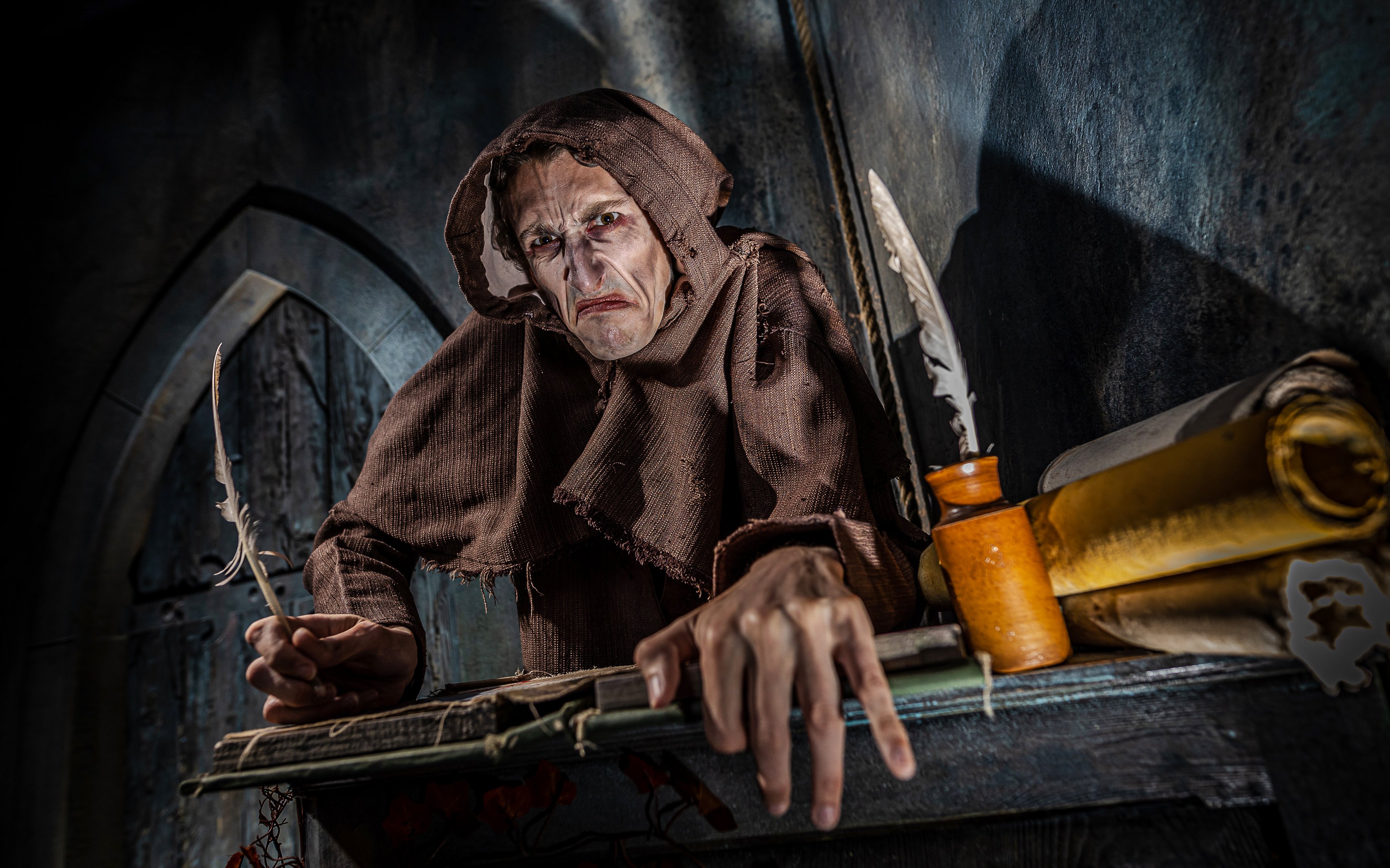 Monk in brown robe with quill at York Dungeon's Vengeance of the Vikings exhibit.