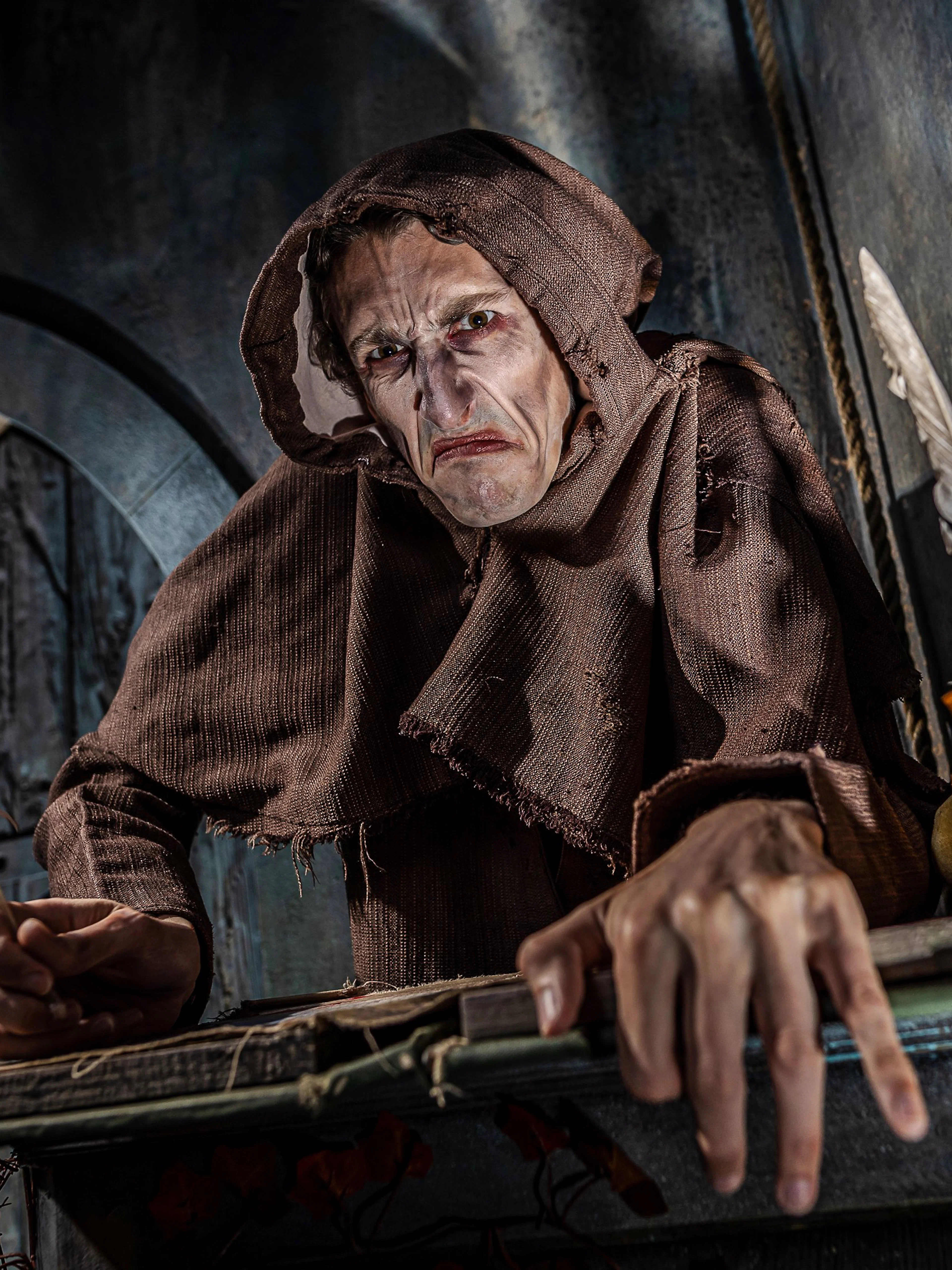 Monk in brown robe with quill at York Dungeon's Vengeance of the Vikings exhibit.