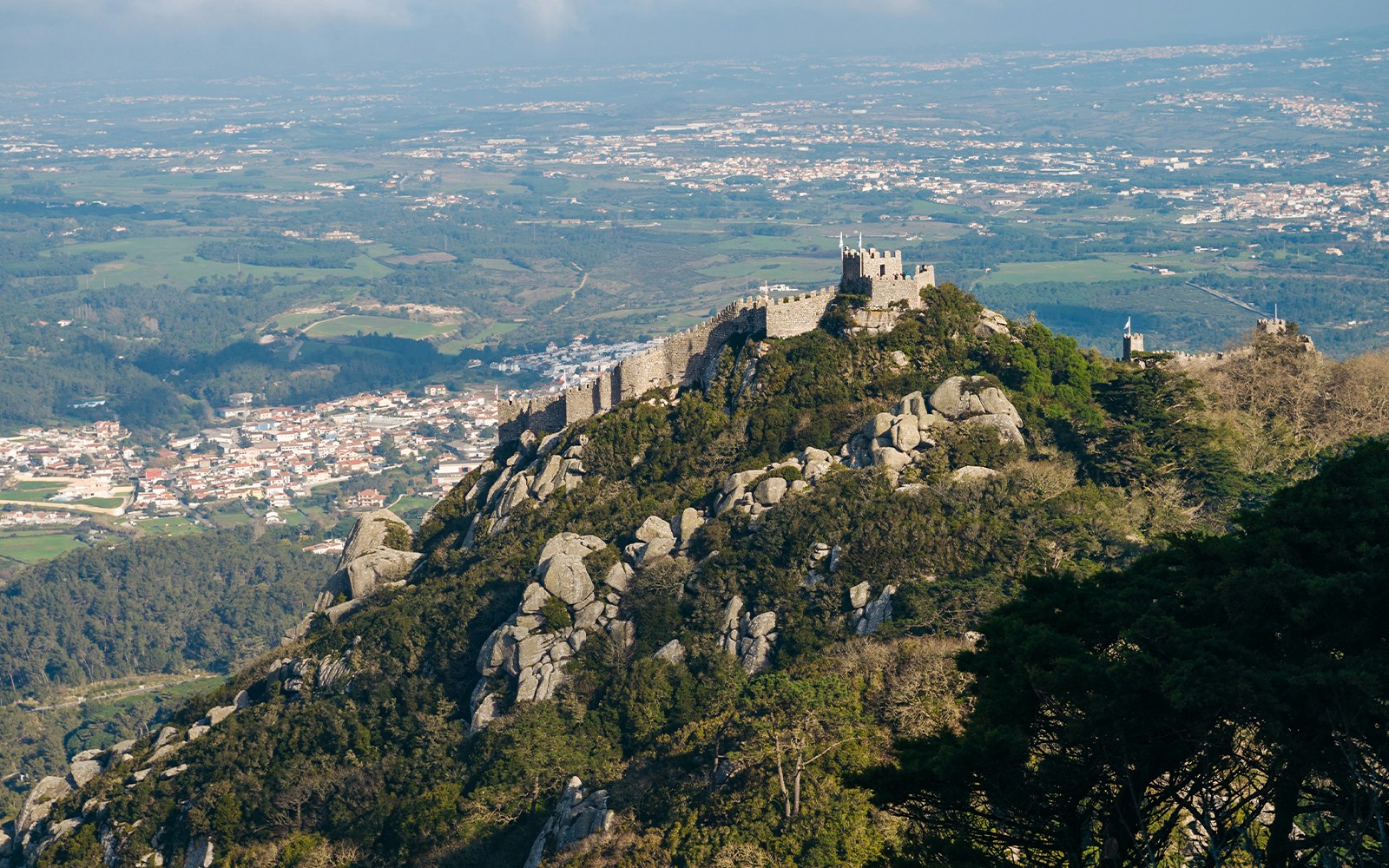 Moorish Castle on a hilltop with Sintra landscape in the background.