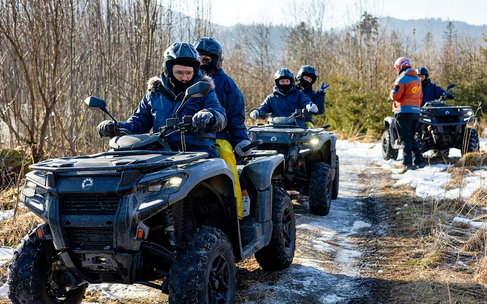 Guests riding quad bikes on a snowy trail in Zakopane.