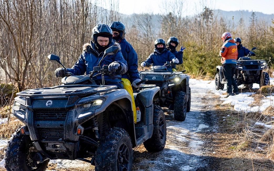 Guests riding quad bikes on a snowy trail in Zakopane.