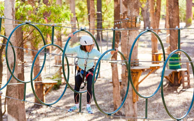 Person navigating rope course in Ludlow Tuart Forest, Western Australia.