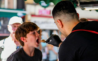 Child tasting street food during Istanbul food tour.
