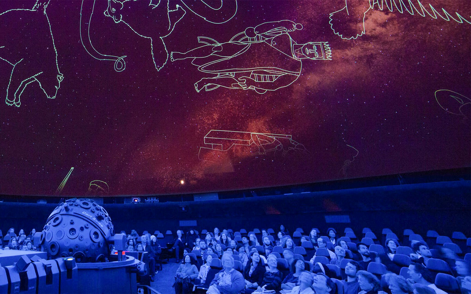 Visitors exploring the Encounters in the Milky Way exhibit at the American Museum of Natural History.
