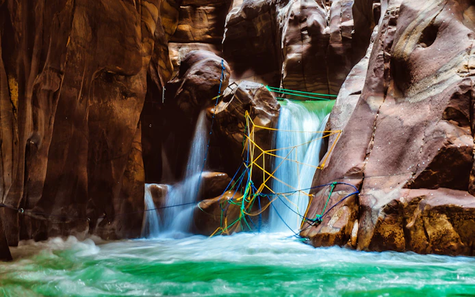 Canyon waterfall with ropes in Wadi Mujib, Jordan near the Dead Sea.