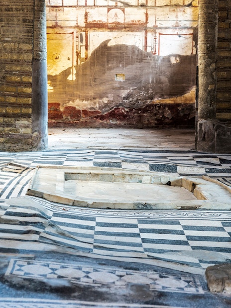 House of the Mosaic Atrium in Herculaneum with intricate floor patterns and ancient walls.
