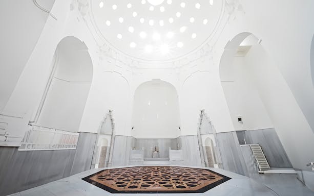 Hurrem Sultan Hamam interior with ornate marble basin in Istanbul.