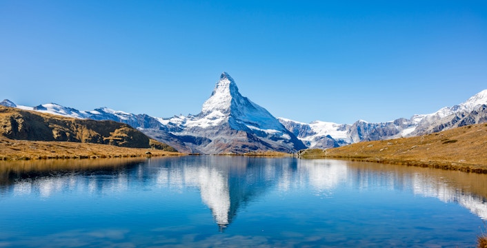 Matterhorn reflected in a clear alpine lake, Zermatt, Switzerland.