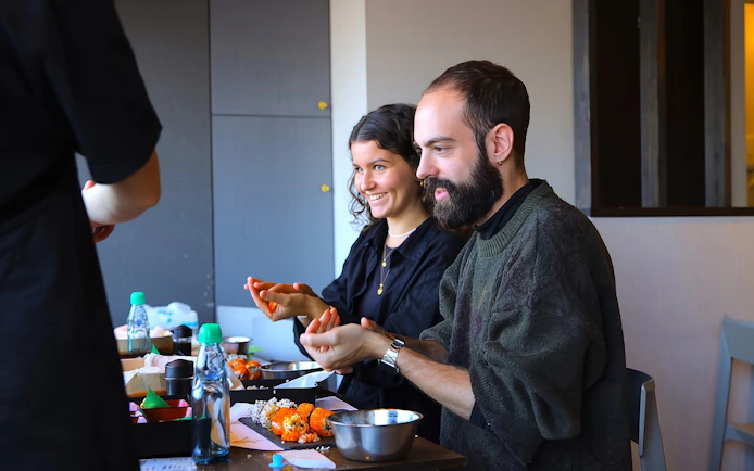 Friends making sushi at a class in Asakusa, Tokyo.