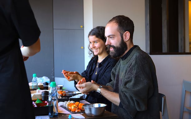 Friends making sushi at a class in Asakusa, Tokyo.